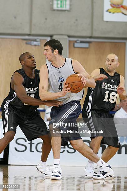 Kosta Koufos of the Utah Jazz drives past Brian Morrison of the San Antonio Spurs at the Salt Lake Community College Campus on July 18, 2008 in Salt...