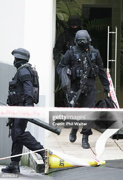 Armed offender squad members leave an inner city apartment block after a male suspect was removed under police custody following a four hour standoff...