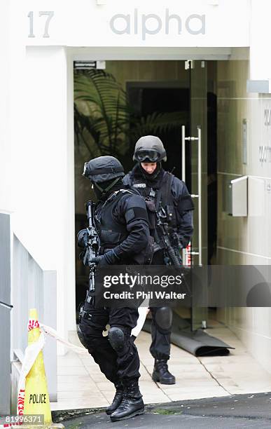 Armed offender squad members leave an inner city apartment block after a male suspect was removed under police custody following a four hour standoff...