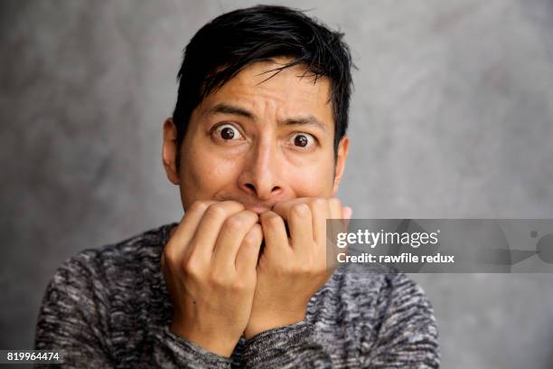 a nervous man - finger in mouth fotografías e imágenes de stock