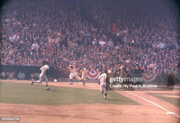 Third baseman Clete Boyer, catcher Johnny Blanchard and pitcher Bill Stafford of the New York Yankees charge at the bunted ball as Bill Mazeroski of...