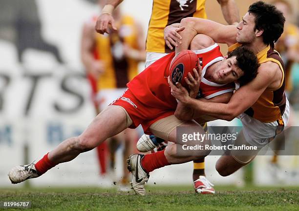 Cameron Pederson of the Hawks tackles Steven Browne of the Bullants during the round 14 VFL match between Northern Bullants and Box Hill Hawks at NAB...