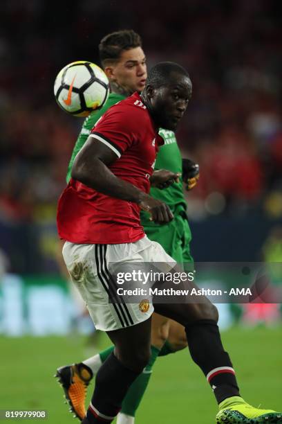 Romelu Lukaku of Manchester United gets the ball past goalkeeper Ederson of Manchester City before scoring a goal to make it 1-0 during the...