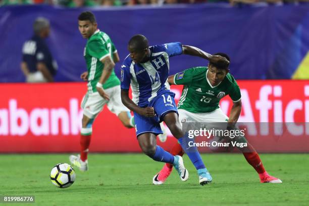 Oscar Boniek of Honduras and Jesus Gallardo of Mexico compete for the ball during the CONCACAF Gold Cup 2017 quarterfinal match between Mexico and...