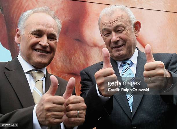 Bavaria's state governor Guenther Beckstein and Erwin Huber, head of the Christian Social Union thumb up prior to a campaign rally after their party...