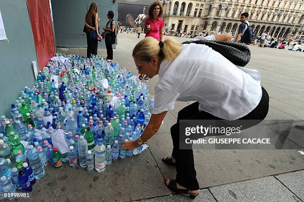 Woman puts down a bottle of water in Piazza del Duomo on July 18 2008, after the court gave the go-ahead for doctors to halt feeding and hydration...