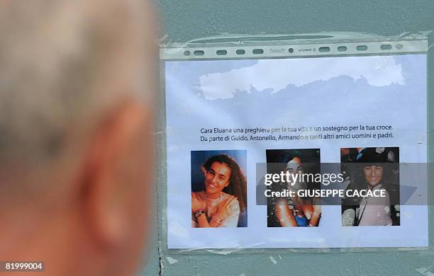 Man looks at pictures of Eluana Englaro in Piazza del Duomo on July 18 2008, after the court gave the go-ahead for doctors to halt feeding and...