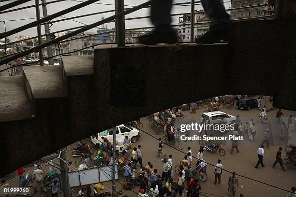 Person runs down a set of stairs above a market place on July 19, 2008 in Dhaka, Bangladesh. According to a recent World Bank study, Bangladesh is...