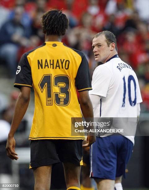 Manchester United's Wanyne Rooney eyes Kaizer Chiefs' Valery Nahayo during Vodacom Challenge Pre Season friendly at Newlands stadium in South Africa...