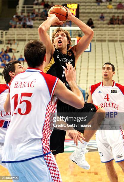 Dirk Nowitzki of Germany in action against Stanko Barac of Croacia compete during the Fiba Olympic Qualifier match between Germany and Croacia at the...