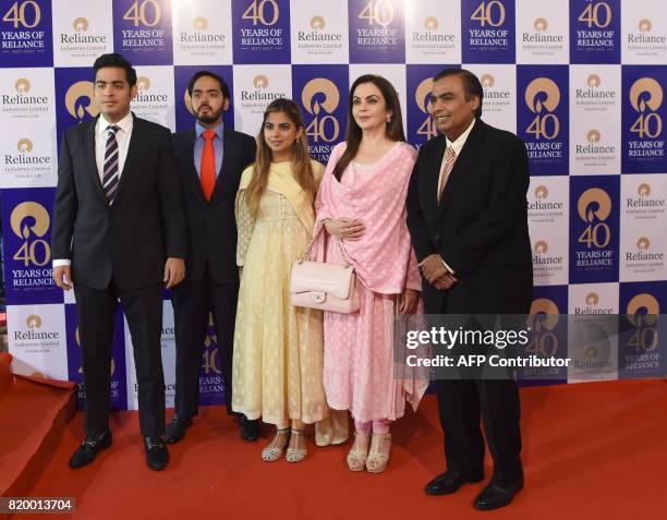 India's richest man and oil-to-telecom conglomerate Reliance Industries chairman Mukesh Ambani and his wife Nita Ambani pose with their children...