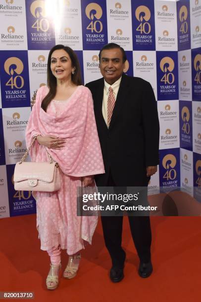 India's richest man and oil-to-telecom conglomerate Reliance Industries chairman Mukesh Ambani and his wife Nita Ambani pose as they arrive for the...