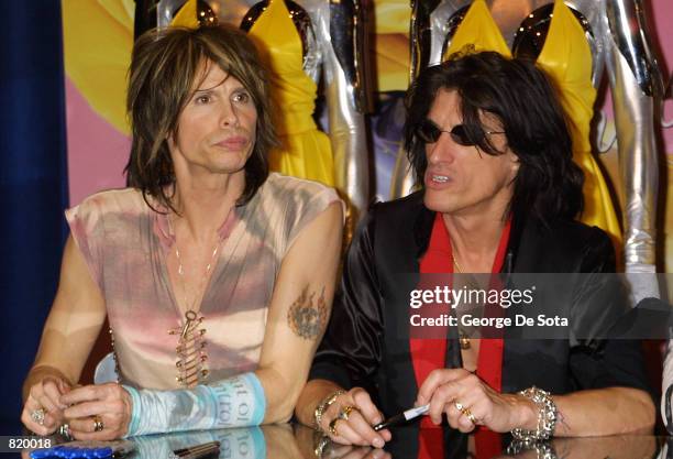 Vocalist Steven Tyler, left, and guitarist Joe Perry of the rock group Aerosmith attend an in-store signing March 16, 2001 at the Virgin records...