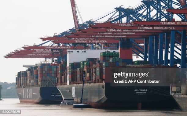 Container ships locked at the port of the container terminal " Burchardkai" in Hamburg northern Germany on July 20,2017. / AFP PHOTO / PATRIK STOLLARZ