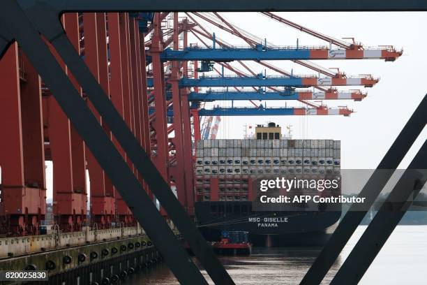 Container ships locked at the port of the container terminal " Burchardkai" in Hamburg northern Germany on July 20,2017. / AFP PHOTO / PATRIK STOLLARZ