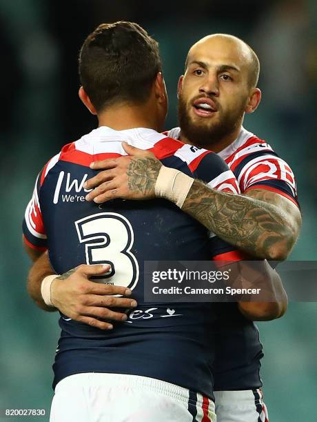 Blake Ferguson of the Roosters celebrates a try with teammate Latrell Mitchell during the round 20 NRL match between the Sydney Roosters and the...