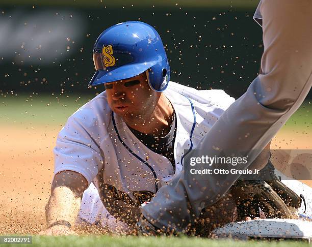 Willie Bloomquist of the Seattle Mariners steals third base against Andy Marte of the Cleveland Indians on July 19, 2008 at Safeco Field in Seattle,...