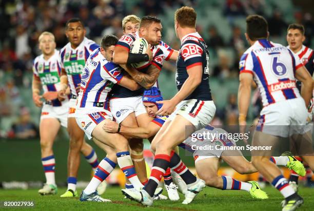 Jared Waerea-Hargreaves of the Roosters is tackled by his opponents during the round 20 NRL match between the Sydney Roosters and the Newcastle...