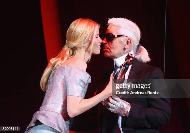 Claudia Schiffer hands Karl Lagerfeld the Platinum award at the ELLE Fashion Star award ceremony during the Mercedes Benz Fashion week spring/summer...