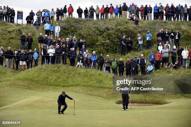Australia's Jason Day and US golfer Zach Johnson on the 2nd green during their second rounds on day two of the Open Golf Championship at Royal...