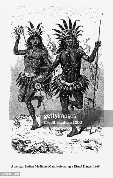 indian medicine men performing a ritual dance engraving, 1869 - shaman headdress stock illustrations