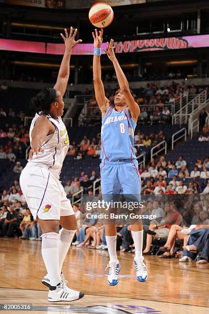 Iziane Castro Marques of the Atlanta Dream shoots against Le'coe Willingham of the Phoenix Mercury on July 19 at U.S. Airways Center in Phoenix,...