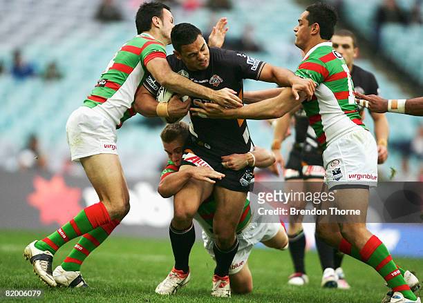Ben Te'o of the Tigers is tackled by the Rabbitohs defence during the round 19 NRL match between the South Sydney Rabbitohs and the Wests Tigers at...