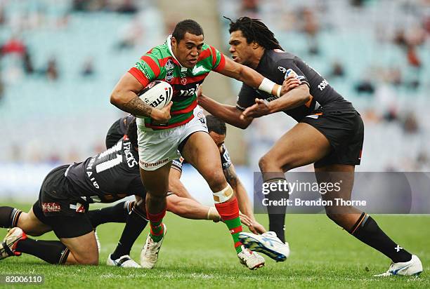 Manase Manuokafoa of the Rabbitohs is tackled by the Tigers defence during the round 19 NRL match between the South Sydney Rabbitohs and the Wests...