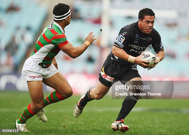 Ben Te'o of the Tigers evades Craig Wing of the Rabbitohs during the round 19 NRL match between the South Sydney Rabbitohs and the Wests Tigers at...