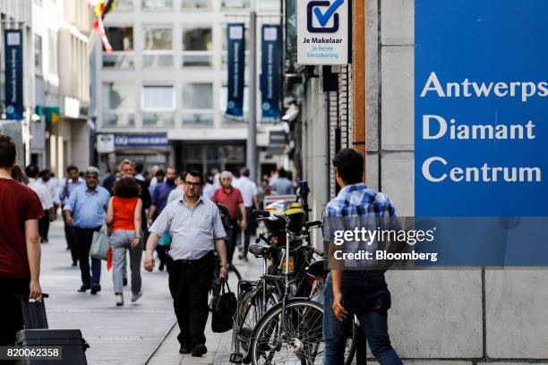 Pedestrians pass a sign outside the Antwerp Diamant Centrum in the diamond district of Antwerp, Belgium, on Thursday, July 20, 2017. An ugly year for...