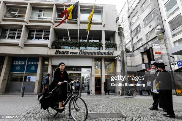Cyclist passes the front of the Beurs voor Diamanthandel diamond exchange in Antwerp, Belgium, on Thursday, July 20, 2017. An ugly year for diamonds...
