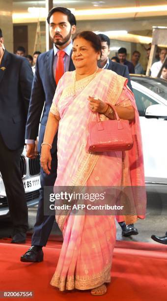 Kokilaben Ambani, mother of India's richest man and oil-to-telecom conglomerate Reliance Industries chairman Mukesh Ambani, arrives with her grandson...