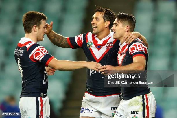 Mitchell Pearce of the Roosters congratulates team mate Connor Watson of the Roosters after scoring a try during the round 20 NRL match between the...