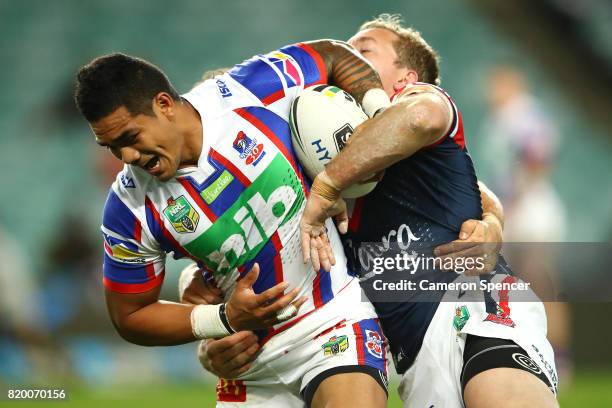 Peter Mata'utia of the Knights is tackled during the round 20 NRL match between the Sydney Roosters and the Newcastle Knights at Allianz Stadium on...