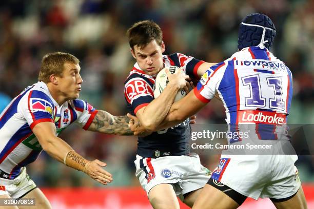 Luke Keary of the Roosters is tackled during the round 20 NRL match between the Sydney Roosters and the Newcastle Knights at Allianz Stadium on July...
