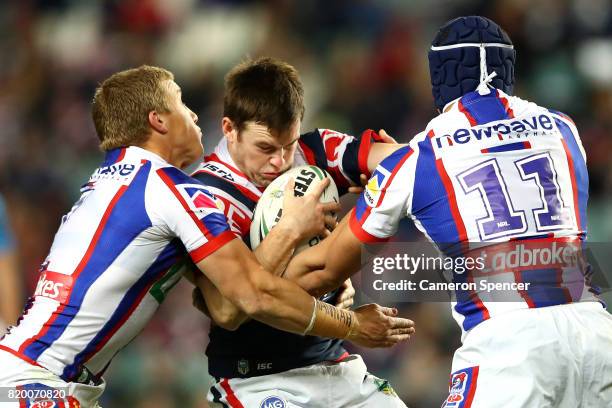 Luke Keary of the Roosters is tackled during the round 20 NRL match between the Sydney Roosters and the Newcastle Knights at Allianz Stadium on July...