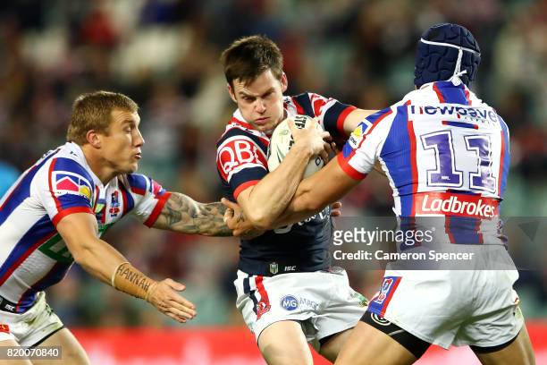 Luke Keary of the Roosters is tackled during the round 20 NRL match between the Sydney Roosters and the Newcastle Knights at Allianz Stadium on July...