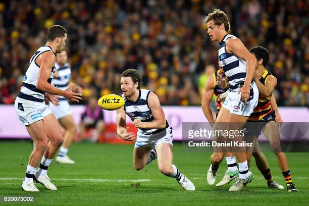 Patrick Dangerfield of the Cats handballs during the round 18 AFL match between the Adelaide Crows and the Geelong Cats at Adelaide Oval on July 21,...