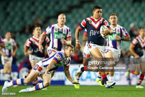 Latrell Mitchell of the Roosters makes a break during the round 20 NRL match between the Sydney Roosters and the Newcastle Knights at Allianz Stadium...