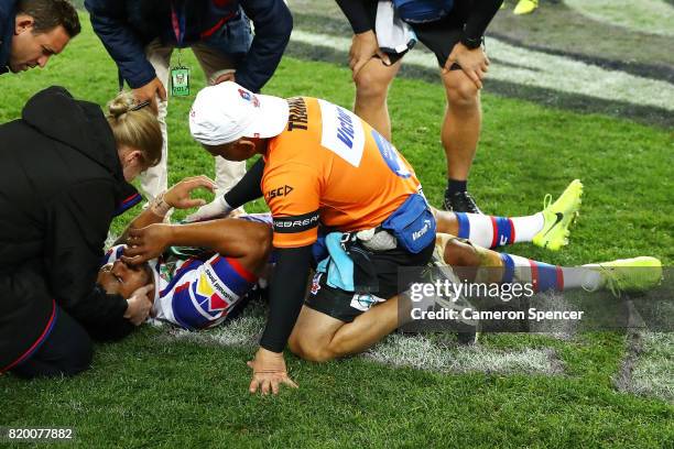 Chanel Mata'utia of the Knights receives medical attention after being knocked out during the round 20 NRL match between the Sydney Roosters and the...