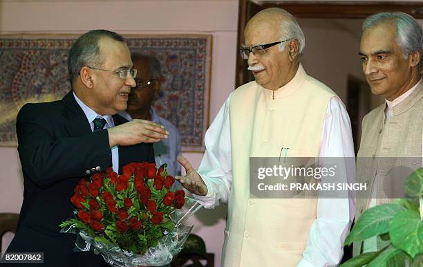 Indian Leader of Oppositon L. K. Advani shakes hands with Pakistan Foreign Secreatary Salman Bashir as Pakistan High Commissioner Shahib Malik looks...