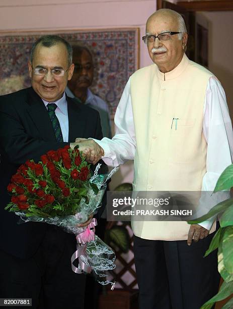 Indian Leader of Oppositon L. K. Advani shakes hands with Pakistan Foreign Secreatary Salman Bashir prior to a meeting in New Delhi on July 20, 2008....