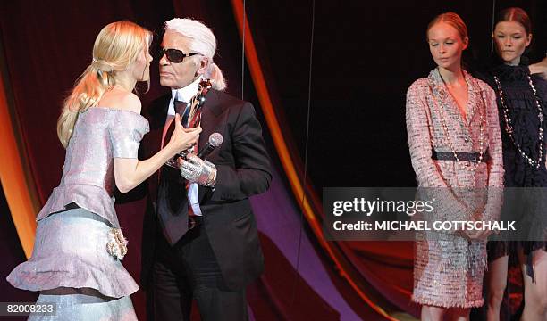 German top model Claudia Schiffer hands over the Mercedes Platinum trophy to fashion designer Karl Lagerfeld during the Elle Fashion Star 2008 award...