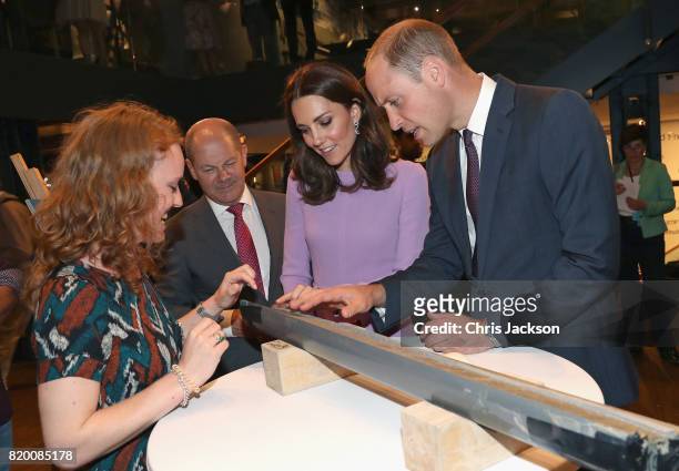 Prince William, Duke of Cambridge and Catherine, Duchess of Cambridge are shown a core sample from under the sea while visiting the Maritime Museum...