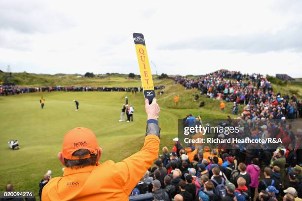 Marshal holds a "Quiet Please" sign during the second round of the 146th Open Championship at Royal Birkdale on July 21, 2017 in Southport, England.