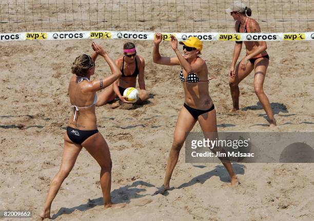 Jennifer Boss and April Ross celebrate a point against Elaine Youngs and Nicole Branagh during the women's quarter-finals of the AVP Brooklyn Open on...