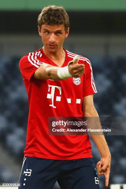 Thomas Mueller of FC Bayern Muenchen jokes with his team mates during a training session at Shenzhen Universiade Sports Centre during the Audi Summer...