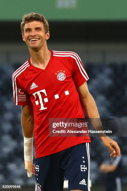 Thomas Mueller of FC Bayern Muenchen jokes with his team mates during a training session at Shenzhen Universiade Sports Centre during the Audi Summer...