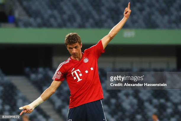 Thomas Mueller of FC Bayern Muenchen jokes with his team mates during a training session at Shenzhen Universiade Sports Centre during the Audi Summer...