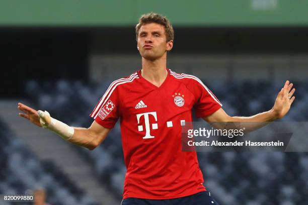 Thomas Mueller of FC Bayern Muenchen jokes with his team mates during a training session at Shenzhen Universiade Sports Centre during the Audi Summer...
